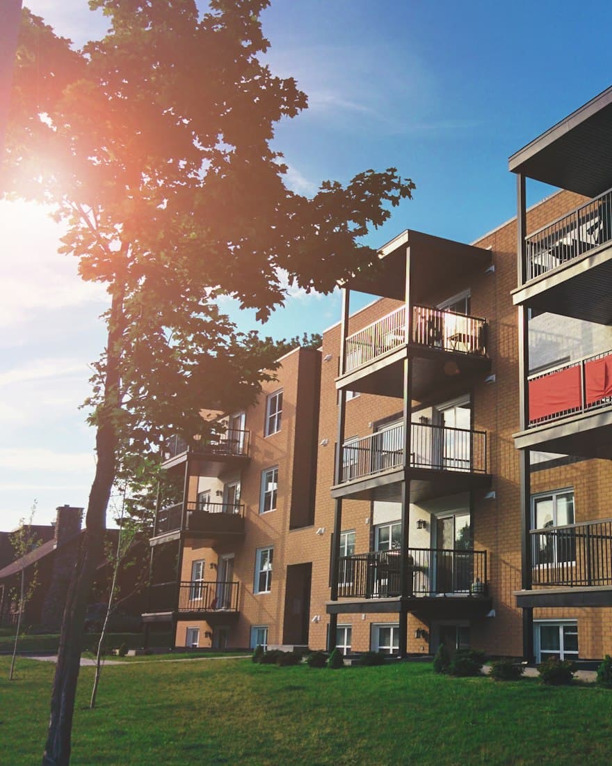 An apartment block with balconies in the afternoon sun